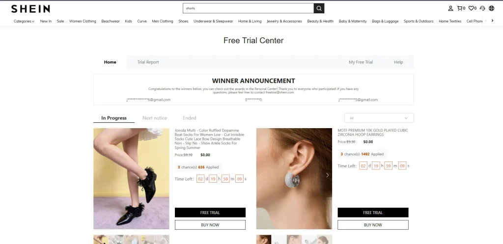 Screenshot of the SHEIN Free Trial Center page. It features a winner announcement banner and two main product listings: ruffled black ankle socks and 18K gold-plated cubic zirconia hoop earrings, both listed at zero dollars with active countdown timers for the trial.