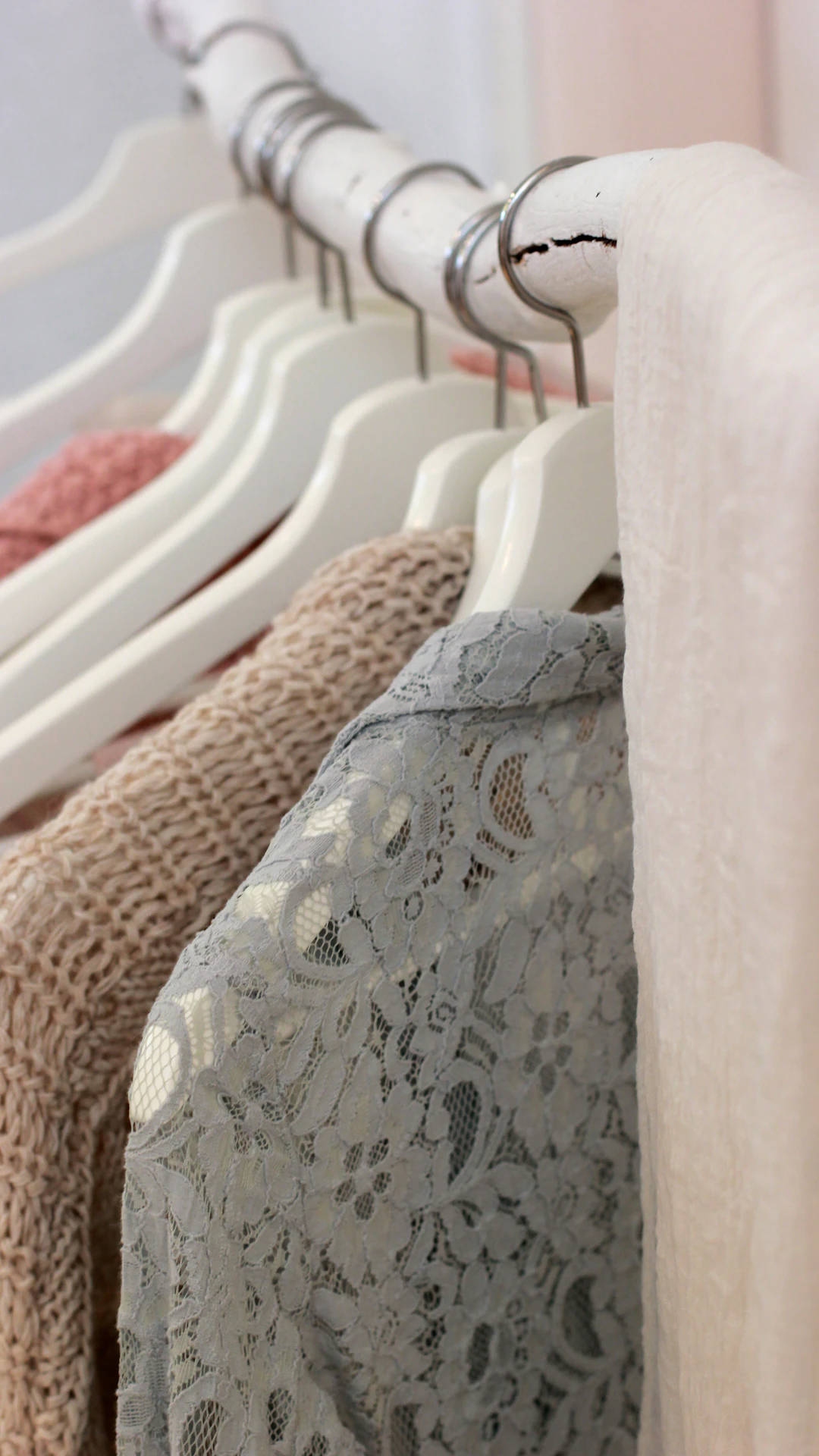 clothes hanging on white rack