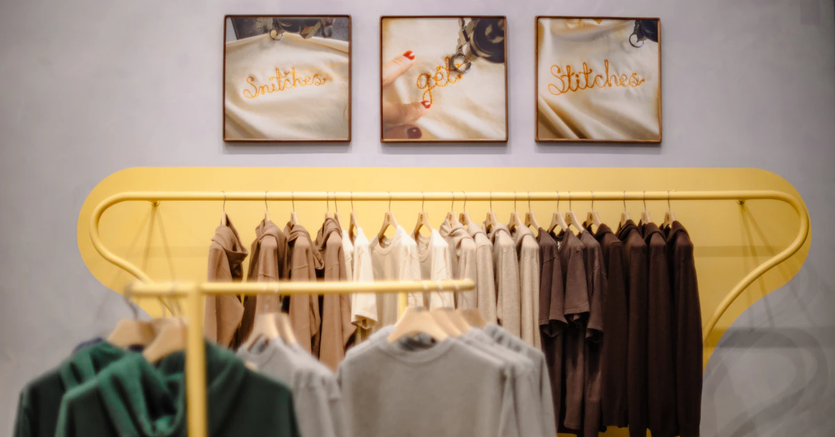 Clothing displayed on a yellow rack in a store